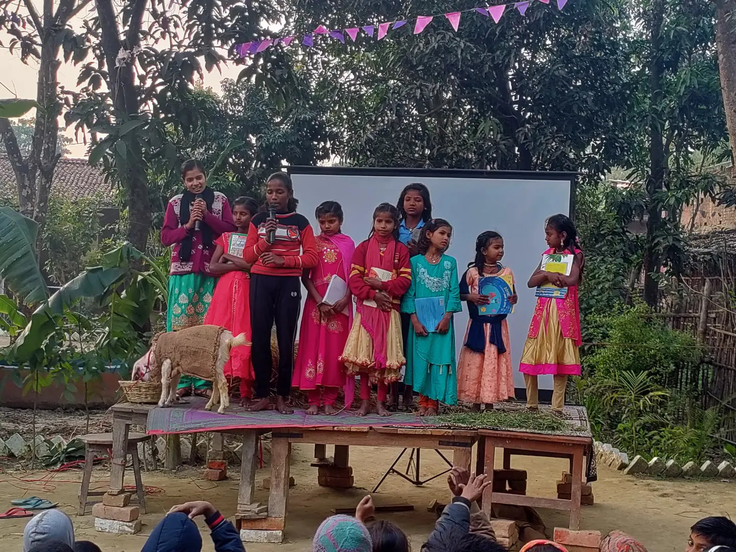 Children performing a play on outdoor stage during Baal-Manch cultural program